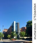 Small photo of Fairfax, Virginia / USA - June 8, 2020: The main entrance to Exploratory Hall stands out against a clear blue sky on the empty, Fairfax campus of George Mason University in the City of Fairfax.