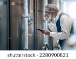 Small photo of Winemaker working in modern large winery factory liquor drink industry quality and fermentation monitor