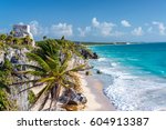 Ruins of Tulum, Mexico and a palm tree overlooking the Caribbean Sea in the Riviera Maya