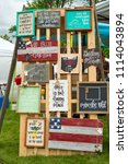 Small photo of TWINSBURG, OH - JUNE 9, 2018: A display of inspirational plaques is part of a vendor booth at A Taste of Twinsburg, a culinary and arts and crafts festival held on the town square.