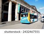 Small photo of EXETER, UK - AUGUST 22, 2023 - The Guildhall shopping centre along Queen Street with a bus in the foreground, Exeter, Devon, UK, Europe, August 22, 2023.