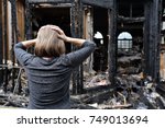 Small photo of A woman is upset about her house which has burned down.