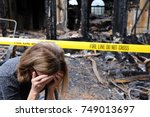 Small photo of A woman is upset about her house which has burned down.