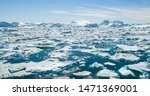 Iceberg and ice from glacier in arctic nature landscape on Greenland. Aerial photo drone photo of icebergs in Ilulissat icefjord. Affected by climate change and global warming.