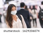Virus mask Asian woman travel wearing face protection in prevention for coronavirus in China. Lady walking in public space bus station or airport.