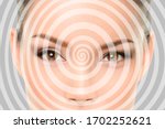 Hypnosis spiral over Asian woman face of hypnotized girl portrait background.
