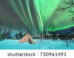 Traditional Sami reindeer-skin tents (lappish yurts) in Troms region of Norway .The polar lights in Norway 