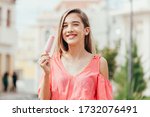 Smiling teen girl with strawberry popsicle outdoors
