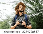 Hiker with backpack using...