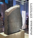 Small photo of LONDON, UK - CIRCA SEPTEMBER 2019: Rosetta Stone stele at the British Museum with text in Ancient Egyptian hieroglyphic, Demotic scripts and Ancient Greek