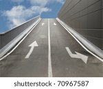 Garage access ramp (with UK left side drive) over a blue sky with clouds
