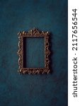 Small photo of Vintage openwork bronze metal frame on a old wall background
