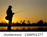 A Fisherman Silhouette Fishing...
