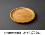 Wooden plate on dark gray...