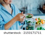 Close up woman adding wheat grass green powder during making smoothie on the kitchen. Superfood supplement. Healthy detox vegan diet. Healthy dieting eating, weight loss program. Selective focus