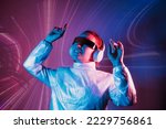 Portrait of a smiling dancing woman in futuristic sunglasses and headphones in pink and blue neon light. Music lover. Silent disco. Woman on the background of music vibes background. Futuristic Party.