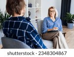 Professional psychotherapy. Female psychologist having session with male patient at mental health clinic, Taking Note During Appointment In Office. Psychological help service. Treatment of depression
