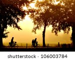 Silhouette Of Two Bicyclers At...