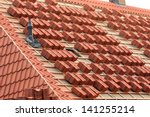 A roof under construction with stacks of roof tiles ready to fasten
