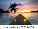 Jetty beach at sunset with candles, romantic seychelles holiday