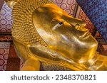 Small photo of BANGKOK, THAILAND - FEBRUARY 5, 2023 Colorful Face Reclining Buddha Wat Phra Chetuphon Wat Pho Po Temple Complex Bangkok Thailand. Temple built in 1600s. Reclining Buddha built in 1832.
