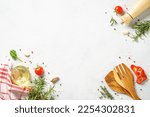 Food background with spices, herbs and utensil on white background.