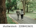 Sport couple walking on the path in the park