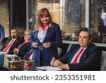 Small photo of University professor carefully listening to her headmaster or rector in meeting at modern college office.
