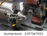 Small photo of The CNC lathe machine forming cutting the metal shaft parts. The hi-technology metal working processing by CNC turning machine .