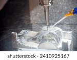 Small photo of The CNC milling machine cutting the mold part with liquid coolant method. The mold parts cutting process by machining center with liquid coolant method.