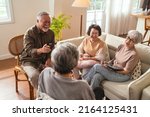 Small photo of old senior asian friends retired people hapiness positive laugh smile conversation together at living room at nursing home Seniors participating in Group Activities in Adult Daycare Center