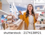 Beautiful asian female woman girl is holding shopping bags and coffee drink, walk and cheerful enjoy smiling while doing shopping in female boutique department store malls happiness window shopping
