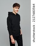 Small photo of Handsome man wear black set of track suit isolated on gray background